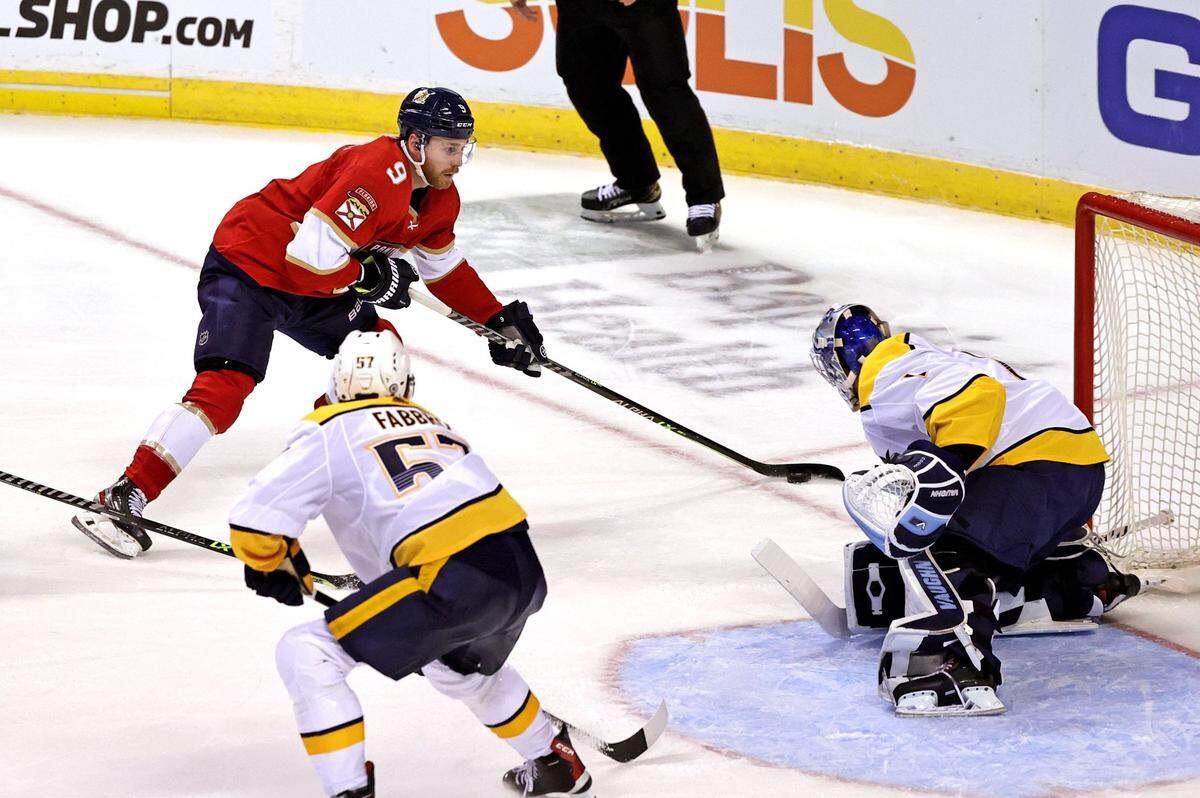 Nashville Predators goaltender Devin Cooley (1) and defenseman Dante Fabbro (57) defend the goal from Florida Panthers center Sam Bennett (9) during the second period of game one of their doubleheader preseason NHL hockey game at FLA Live Arena on Sunday, September 26, 2021 in Sunrise, Florida.