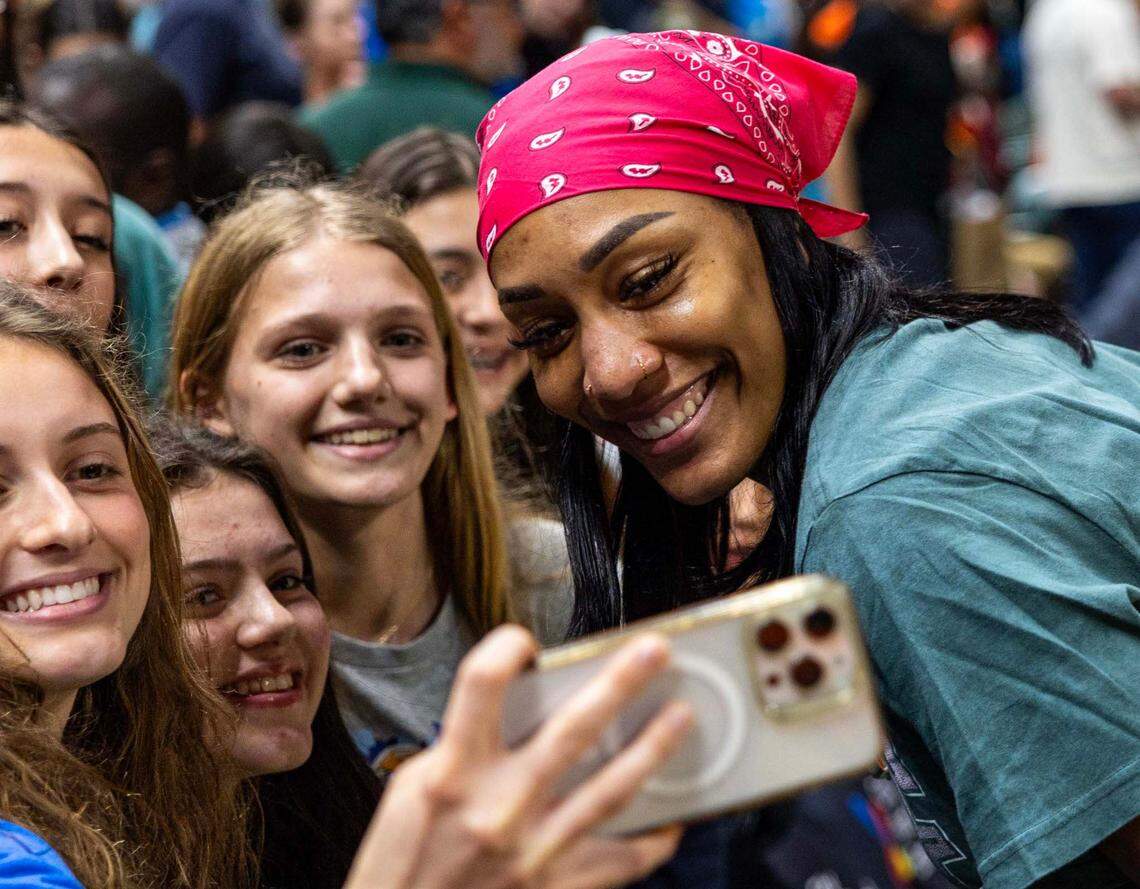WNBA player A’ja Wilson takes a photo with fans after the second half of an NCAA women’s basketball game between the Miami Hurricanes and the North Carolina Tar Heels at the Watsco Center on Sunday, Dec. 29, 2024, in Coral Gables, Fla.