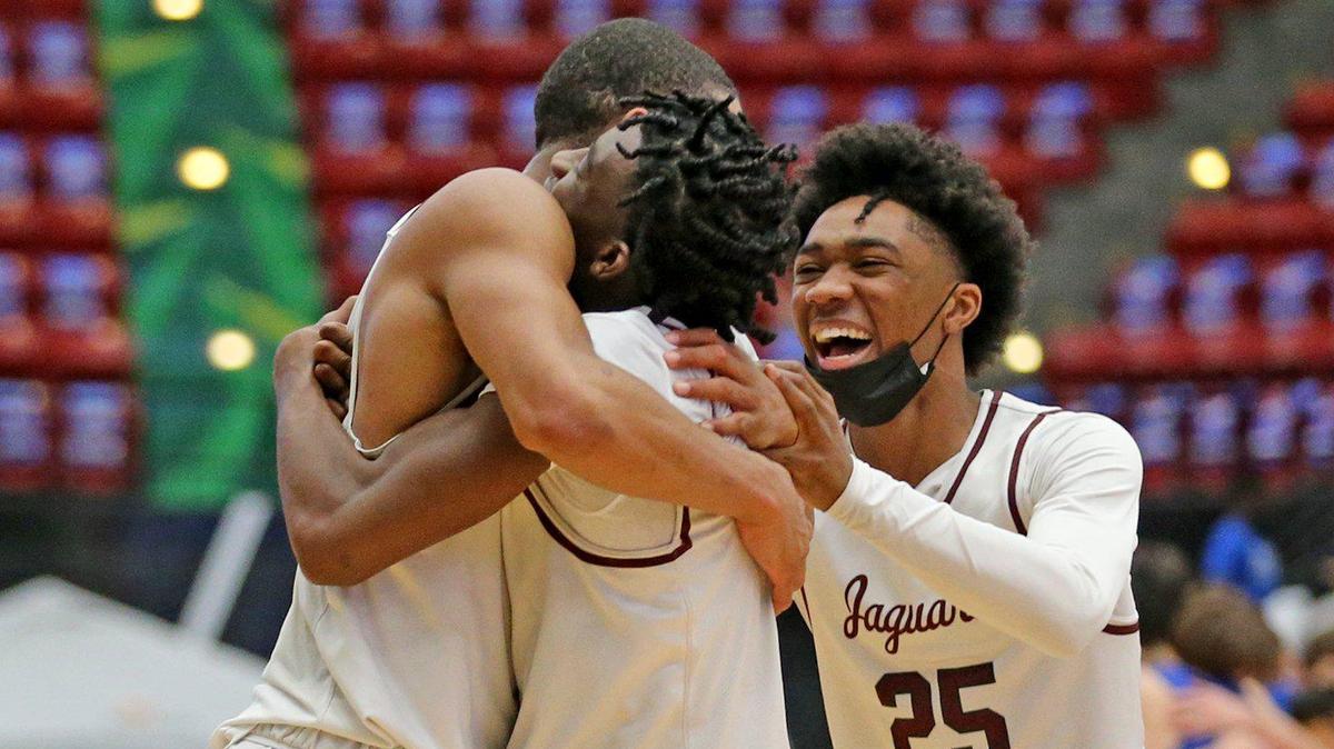 Pembroke Pines Charter Elijah Wyche (10), Kolby King (5) and players off the bench as they defeat Jesuit in overtime in the FHSAA 5A Boy’s Basketball semifinals in Lakeland, Florida, Thursday, March 4, 2021.