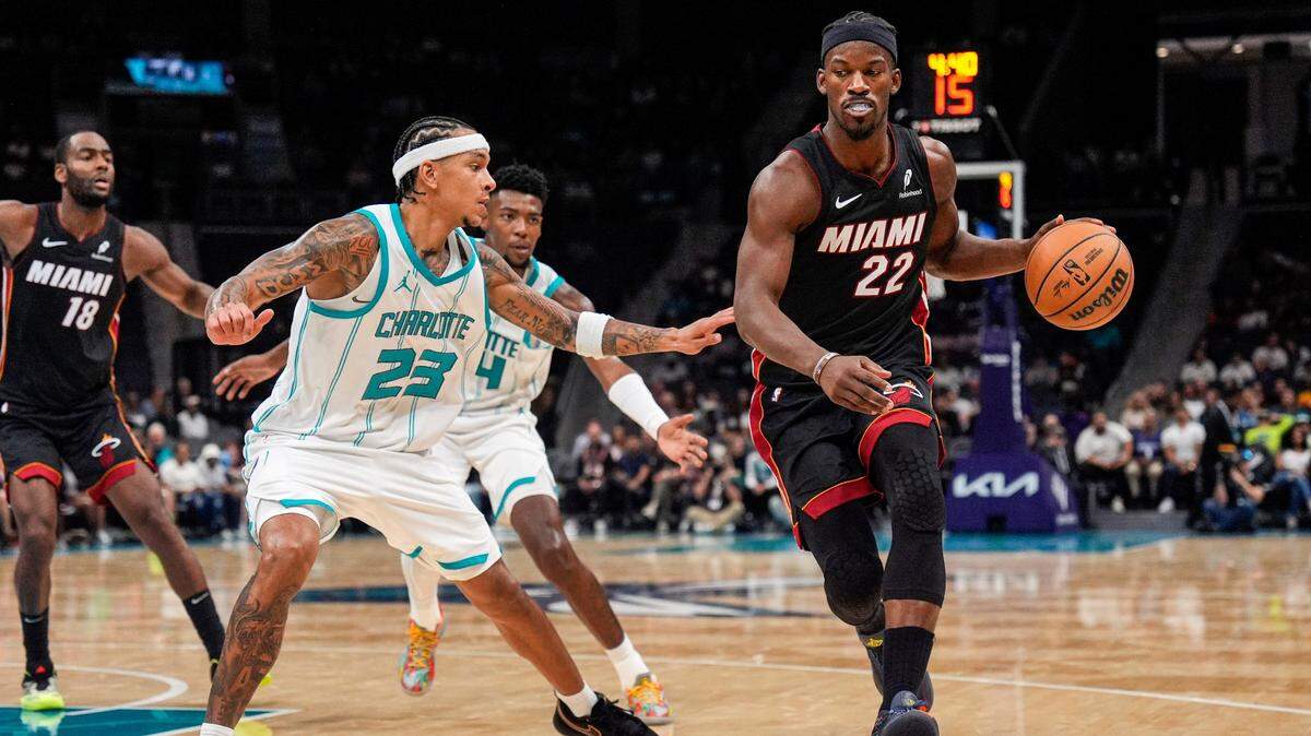 Charlotte Hornets guard Tre Mann (23) guards Miami Heat forward Jimmy Butler (22) during the second quarter at Spectrum Center.