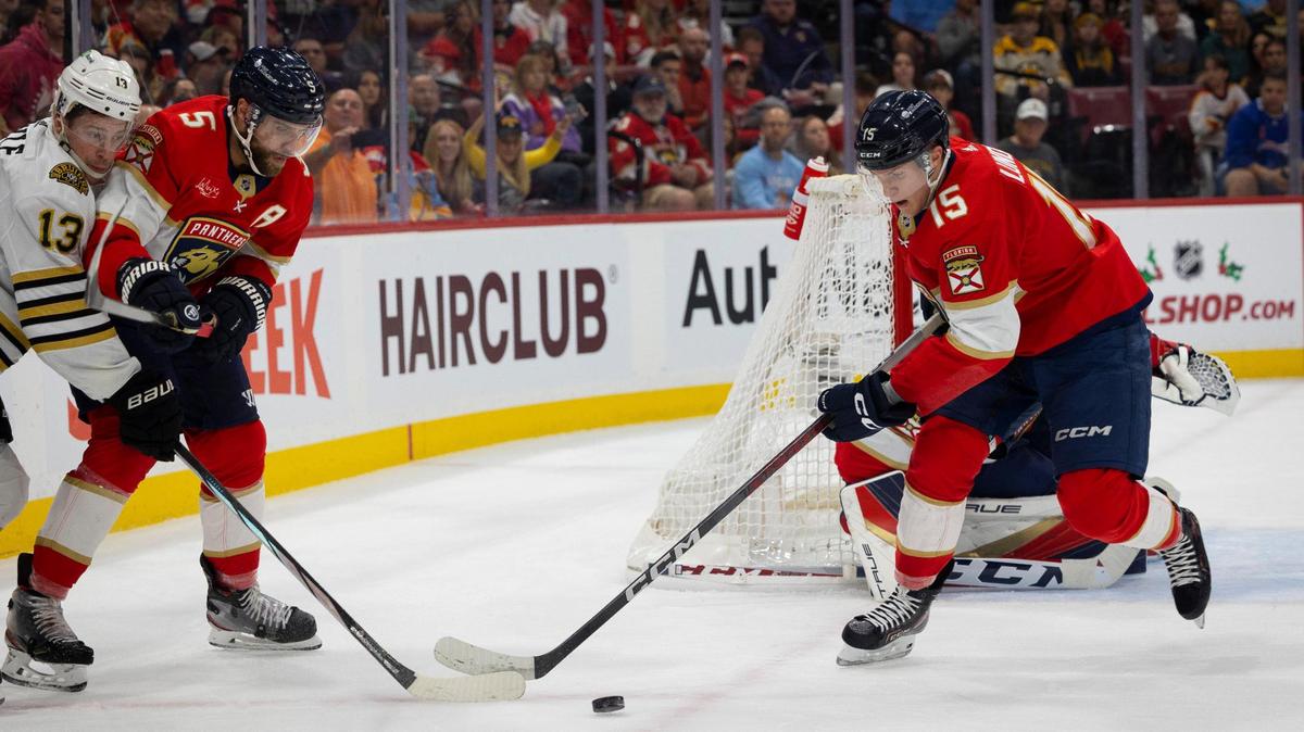 Florida Panthers center Anton Lundell (15) and defenseman Aaron Ekblad (5) keep the puck from Boston Bruins center Charlie Coyle (13) during the first period of a NHL game on Wednesday, Nov. 22, 2023, at Amerant Bank Arena in Sunrise, Fla.