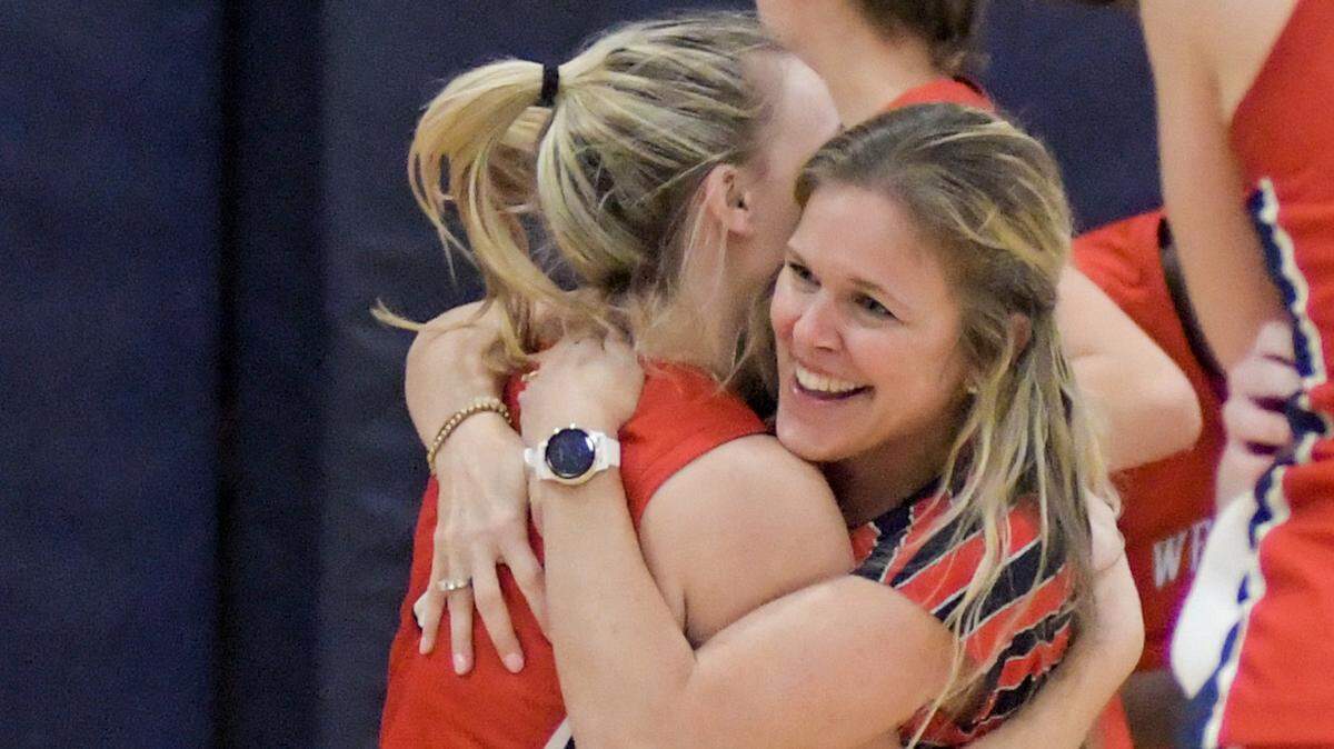 Westminster Academy coach Shannon Wallhoff celebrates with senior point guard Claire Erickson beating Miami Country Day in the Region 4-3A final on Friday, Feb. 18, 2022.