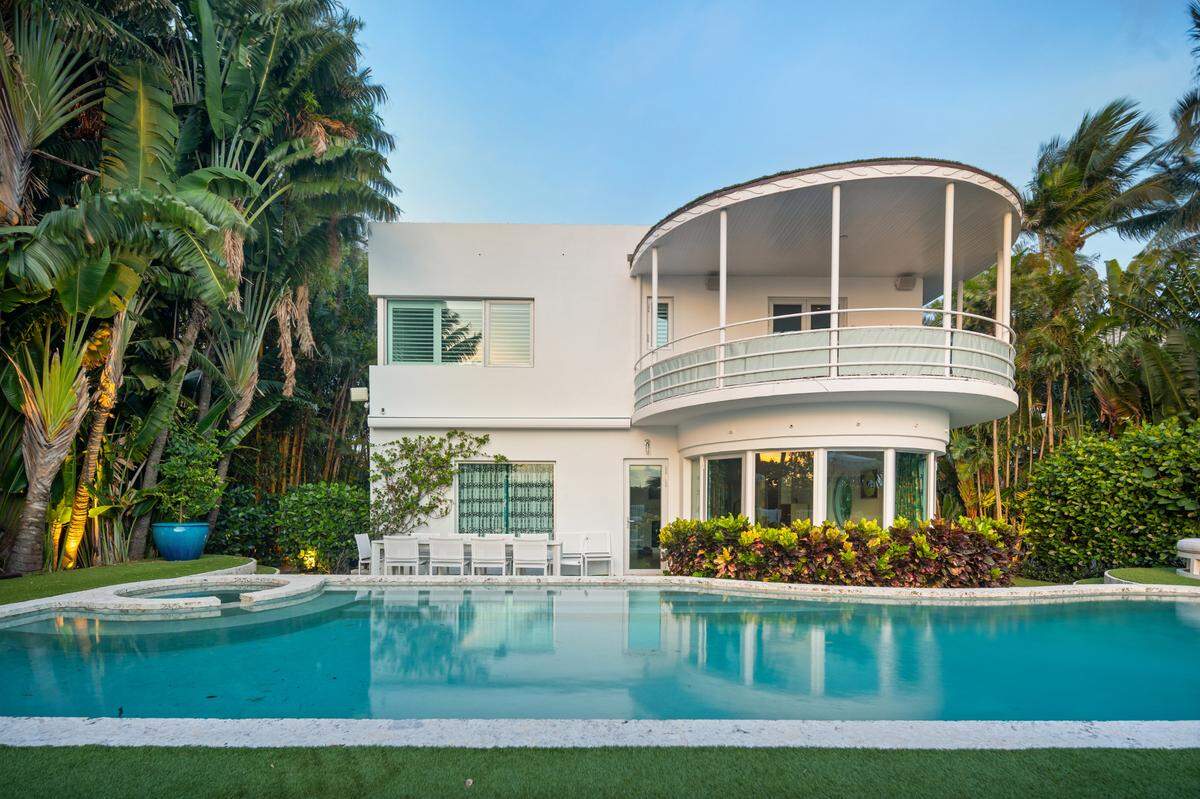This nautically themed Art Deco home faces prow-forward toward dramatic sunsets, its rooftop deck overlooking the pool, dock and sparkling Intracoastal.