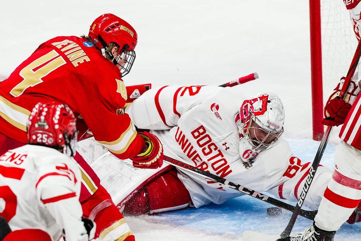 Apr 11, 2024; Saint Paul, Minnesota, USA; Boston U. goaltender Mathieu Caron (62) makes a save on Denver forward Jack Devine (4) in the semifinals of the 2024 Frozen Four college ice hockey tournament during the third period at Xcel Energy Center.