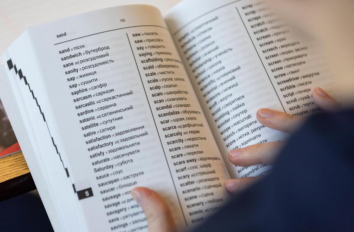 Andrii Kudrynskyi, 12, a 7th grader from Ukraine, uses a Ukrainian word-to-word bilingual dictionary in his ESOL class at Aventura Waterways K8 Center on Thursday, Sept. 5, 2024, in Aventura, Fla.