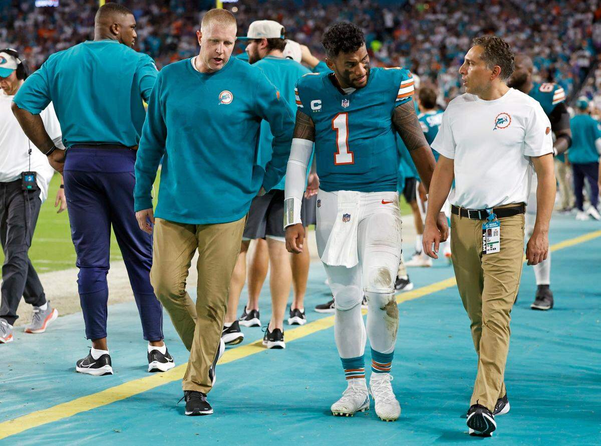 Miami Dolphins quarterback Tua Tagovailoa (1) is assisted off the field in the third quarter after an injury during the game against the Buffalo Bills in an NFL game at Hard Rock Stadium on Thursday, September 12, 2024.