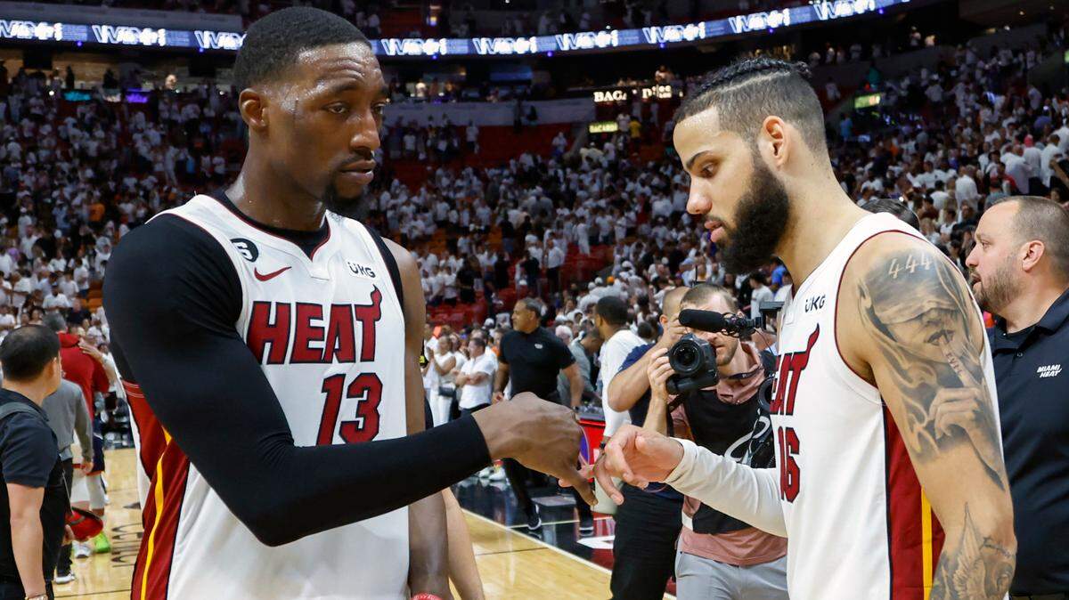 Miami Heat center Bam Adebayo and forward Caleb Martin celebrate after a series-clinching win over the New York Knicks in Game 6 of the NBA Eastern Conference Semifinals at the Kaseya Center in Miami on Friday, May 12, 2023.