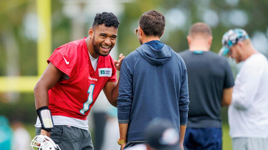 Miami Dolphins quarterback Tua Tagovailoa (1) talks with Dolphins head coach Mike McDaniel during NFL football training camp at Baptist Health Training Complex in Hard Rock Stadium on Thursday, September 1, 2022 in Miami Gardens, Florida.