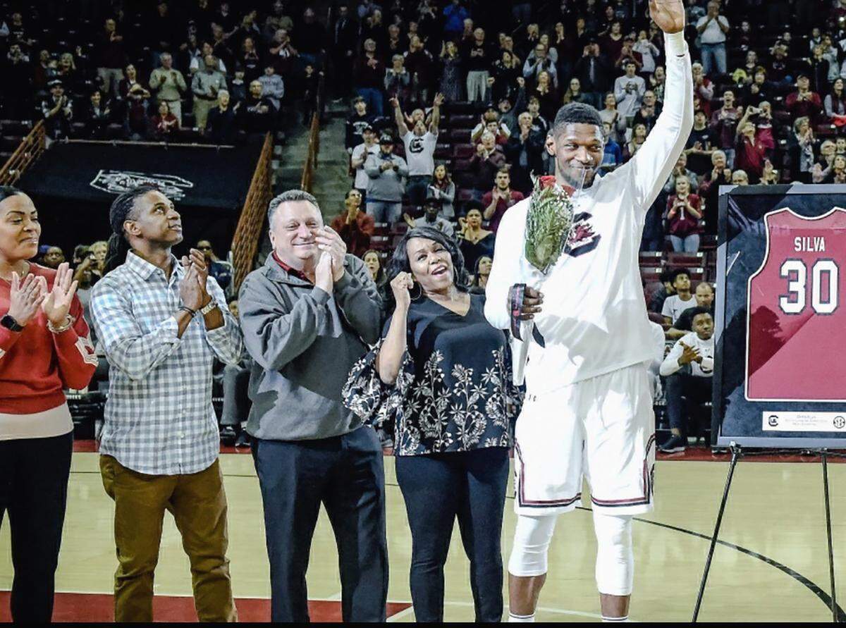 Miami Heat rookie Chris Silva on senior night at the University of South Carolina, with Tommy Sacks watching on.