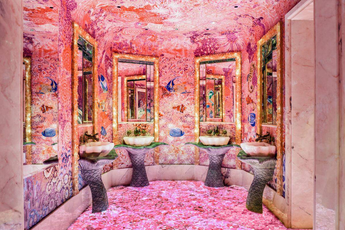The sinks in the women’s room rest on mermaid tails.