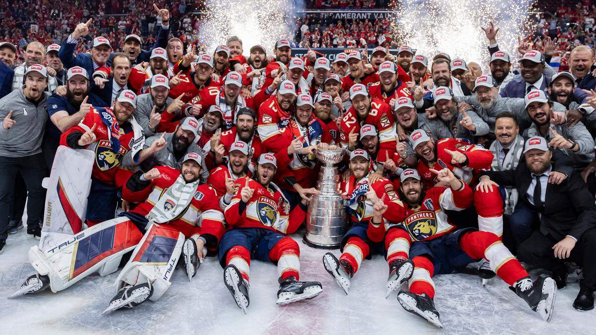 The Florida Panthers gather around the Stanley Cup for a team photo after defeating the Edmonton Oilers in Game 7 of the Stanley Cup Final at Amerant Bank Arena on Monday, June 24, 2024, in Sunrise, Fla.