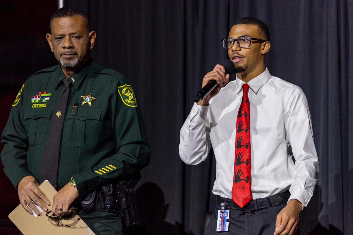 Miramar High School student Elias Ortega, right, speaks to the audience alongside Broward County Sheriff’s Office Lt. R. Smith during the 5000 Role Models Police & Youth Conference.