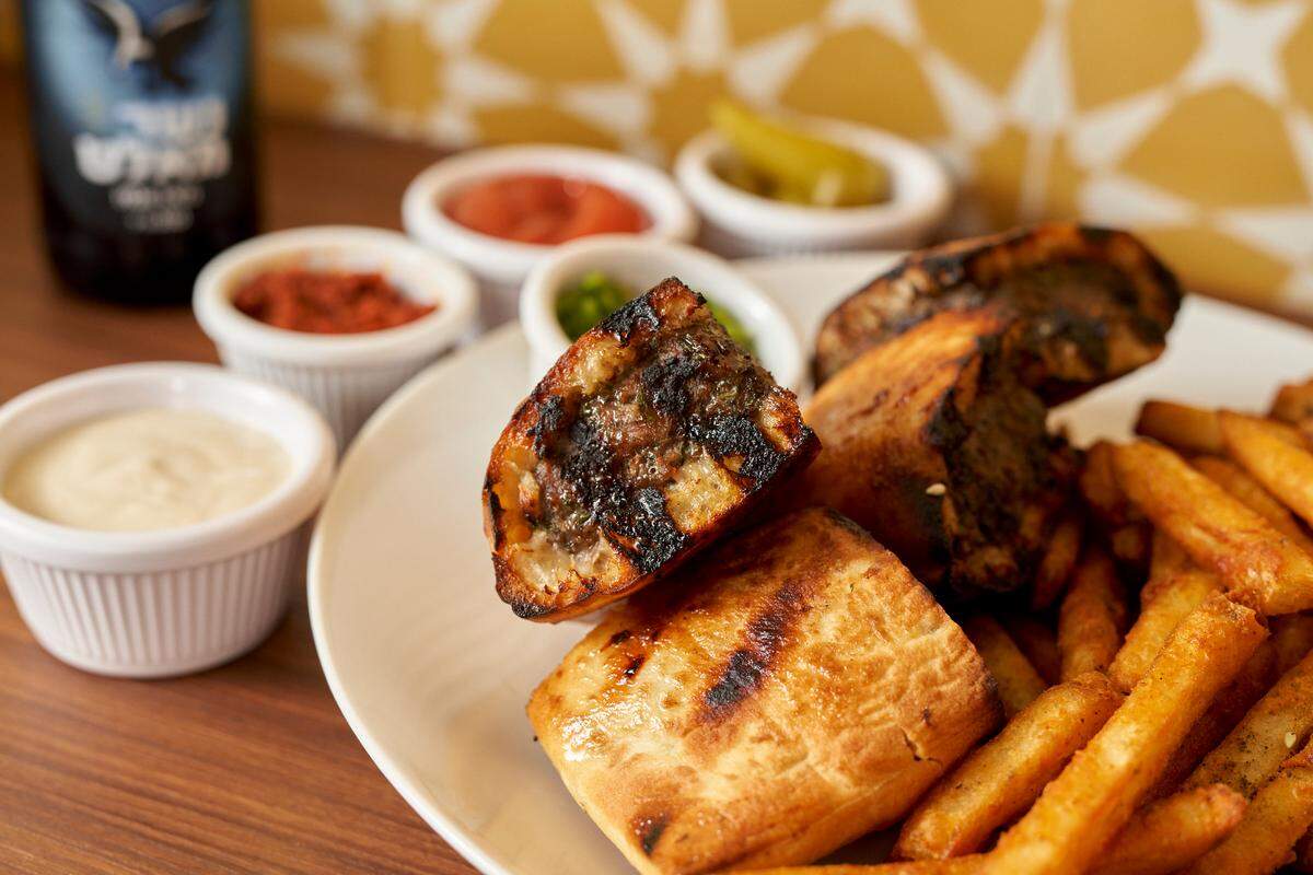 The Arayes burger, a Lebanese-style grilled beef-stuffed pita, doesn’t look like a traditional burger, but it has won the People’s Choice award at the last two Burger Bashes at the South Beach Wine & Food Festival.