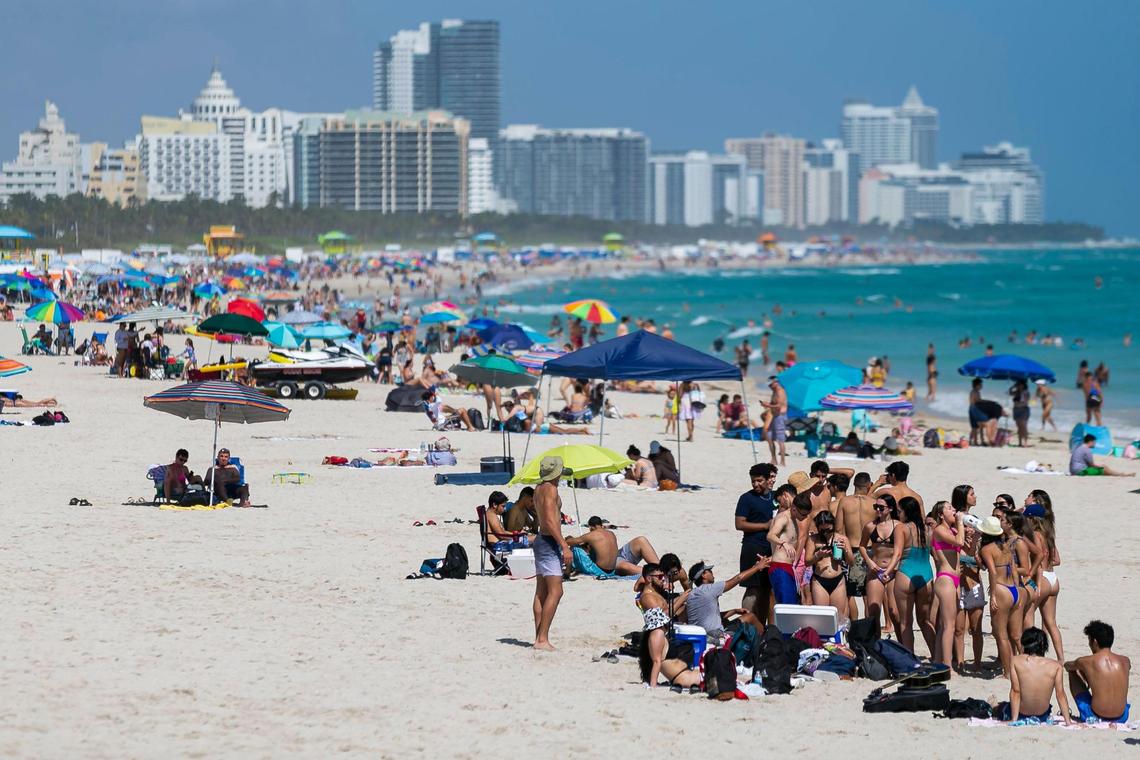 Beachgoers visit Miami Beach, Florida on Monday, February 15, 2021.