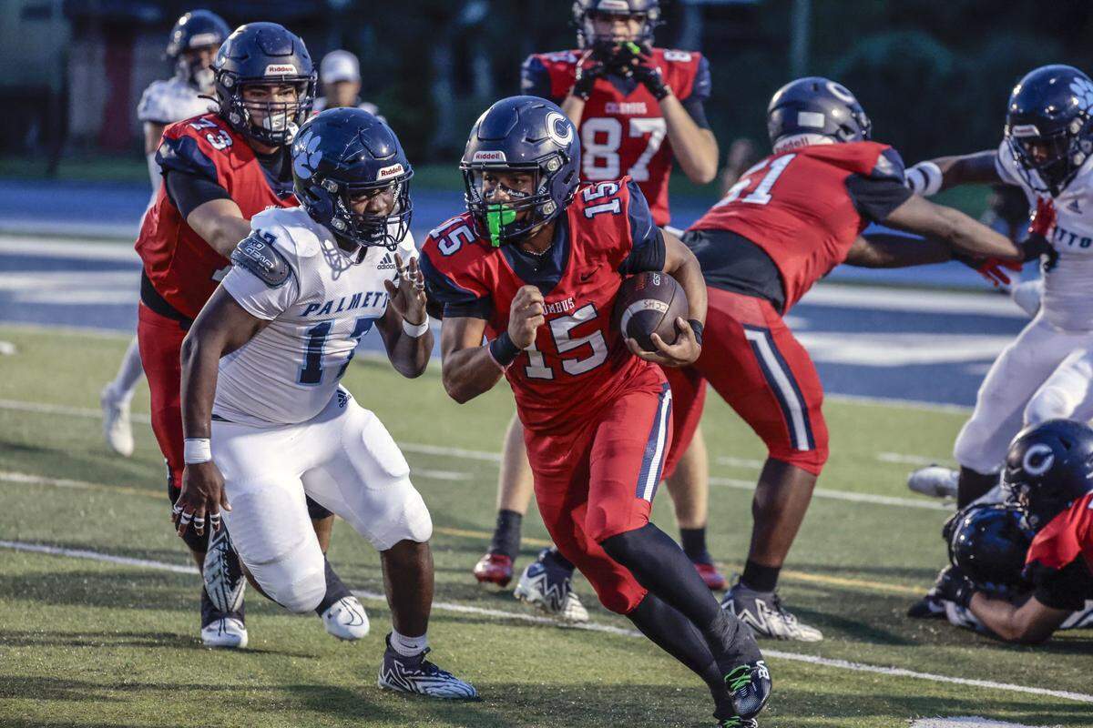 Columbus Explorer High’s running back Shawn James (15) runs the ball as Miami Palmetto High’s linebacker Bomani Francis gives chase in the first half at Tropical Park in Miami, Florida on Friday, September 12, 2025.