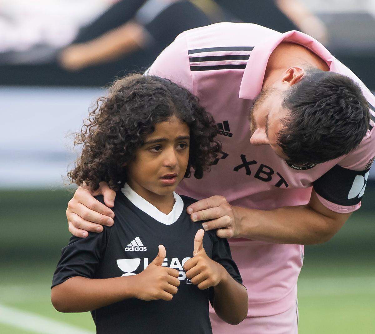 Inter Miami forward Lionel Messi (10) comforts Asahd Khaled before a Leagues Cup group stage match against Atlanta United at DRV PNK Stadium on Tuesday, July 25, 2023, in Fort Lauderdale, Fla.