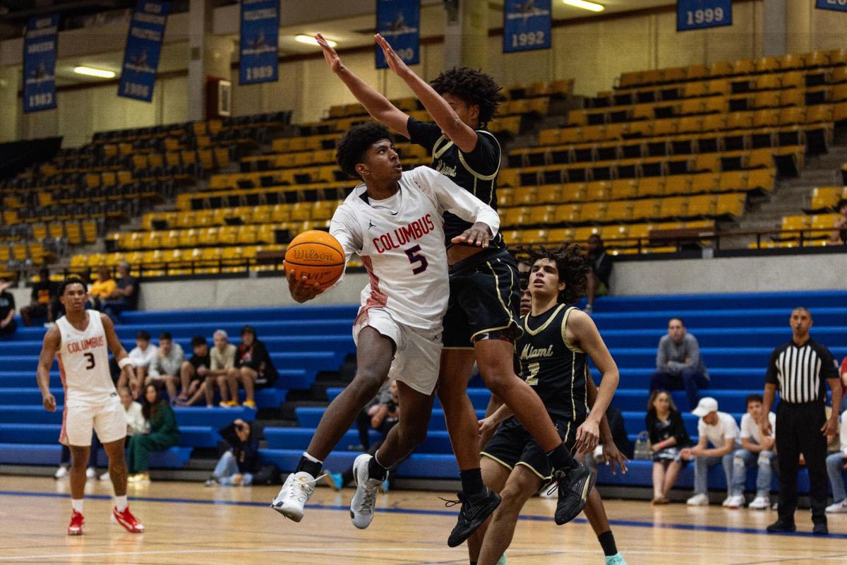 Columbus guard Jaxson Richards (5) lays the ball up around Miami High forward Jean Joseph (1) during the second half of the GMAC Basketball Finals at Miami-Dade Kendall campus gym in Miami, Florida on Saturday, January 27, 2024.