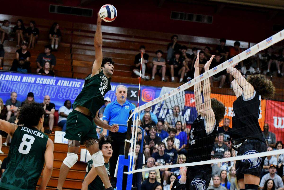 Reagan senior outside hitter Yeison Gonzalez unleashes a hard shot against Lake Howell during the FHSAA Class 2A boys volleyball state championship match on Saturday at Polk State College in Winter Haven.