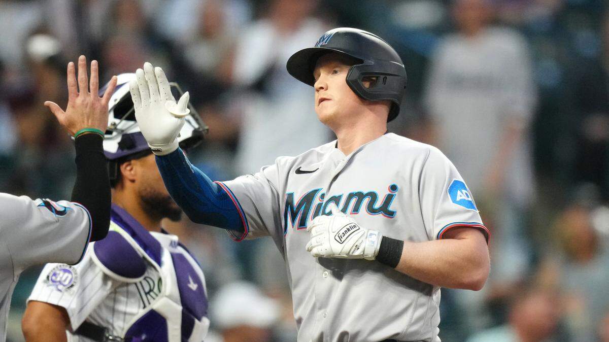 May 23, 2023; Denver, Colorado, USA; Miami Marlins first baseman Garrett Cooper (26) celebrates his two-run home run in the sixth inning against the Colorado Rockies at Coors Field. Mandatory Credit: Ron Chenoy-USA TODAY Sports