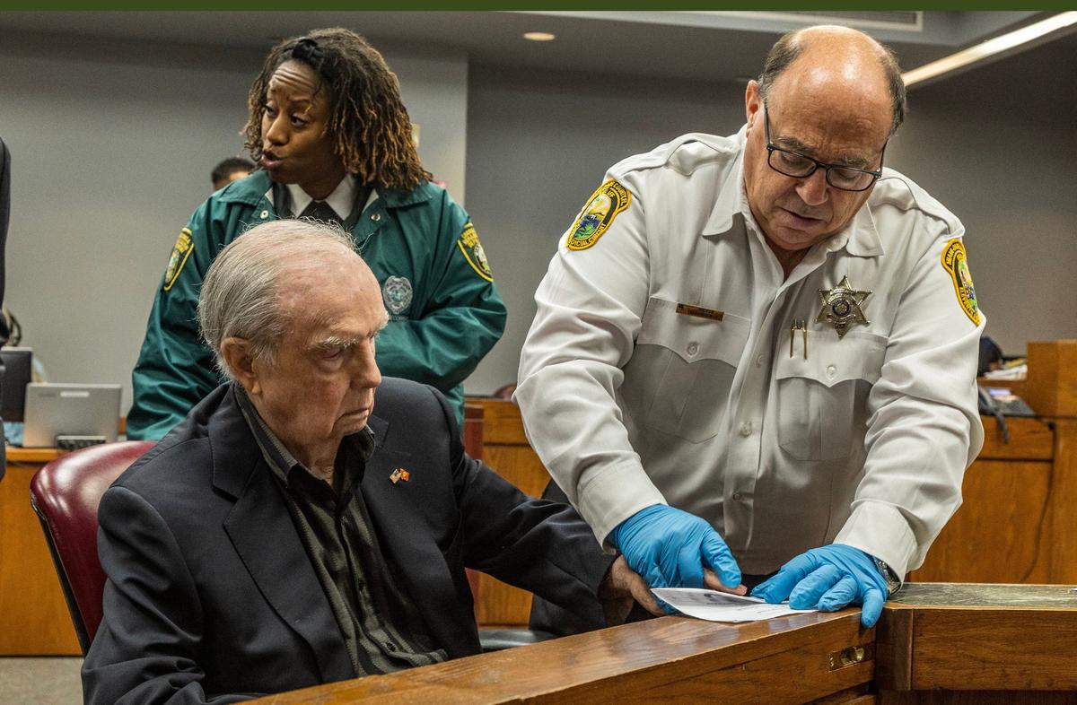 Bailiff Victor Abbondandolo fingerprints Albert Bassett during his plea deal hearing in front of Miami-Dade Circuit Court Judge Alberto Milian at the Gerstein Justice Building in Miami on Tuesday, May 28, 2024. As part of the plea deal, Bassett pleaded guilty to four counts of aggravated child abuse, but does not have to register as a sex offender.