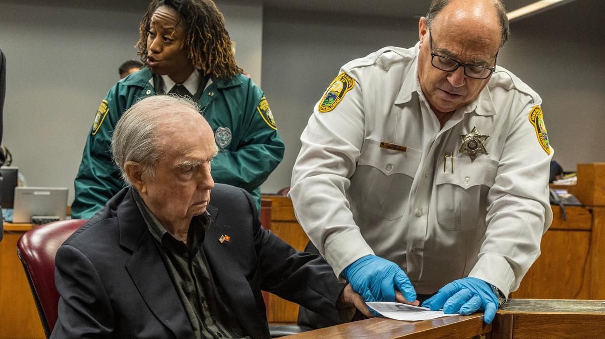 Bailiff Victor Abbondandolo fingerprints defendant Albert Bassett during his plea deal hearing in front of Judge Alberto Milian at the Gerstein Justice Building in Miami on Tuesday, May 28, 2024. Basset was previously charged with four counts of sexual battery on a minor and three counts of lewd and lascivious conduct. Under the plea deal approved Tuesday, he won’t have to register as a sexual offender.