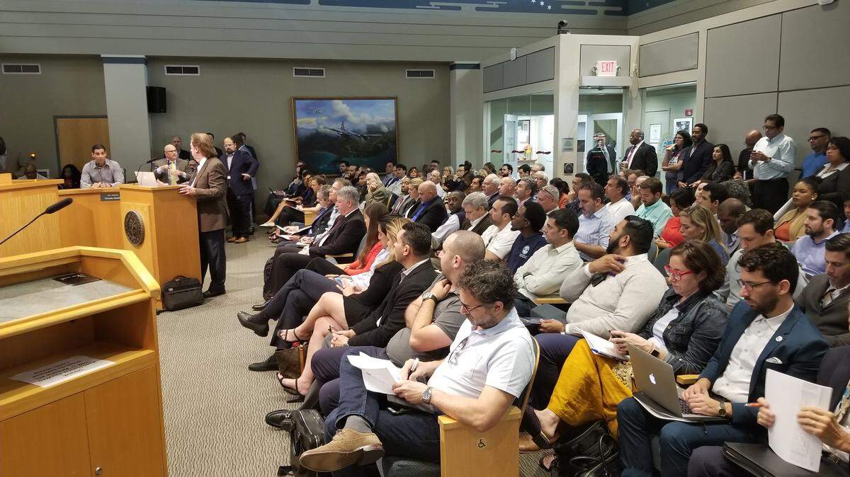 Ned Murray, associate director of the FIU Metropolitan Center and principal investigator and contributing author of the Miami Affordable Housing Master Plan, addresses Mayor Francis Suarez from the podium at City Hall on Wednesday during the first public hearing of the details of the 10-year plan.