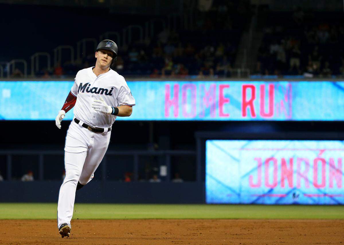 Miami Marlins first baseman Garrett Cooper (26) rounds the bases after hitting a grand slam during the second inning of an Major League Baseball game against the St. Louis Cardinals at Marlins Park in Miami on Wednesday, June 12, 2019.
