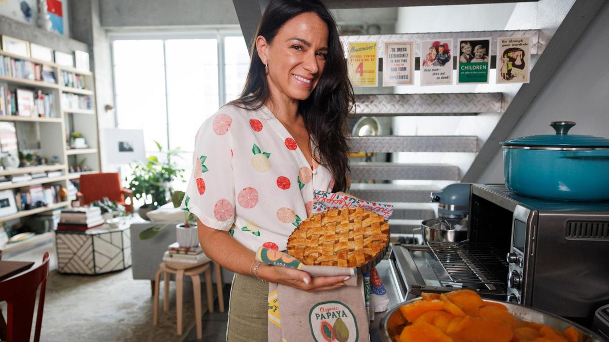 Natalia Martinez-Kalinina, co-founder of a Miami startup, poses with one of the mango pies she makes. She has started Sunny Slice Co., an online business selling them via social media.