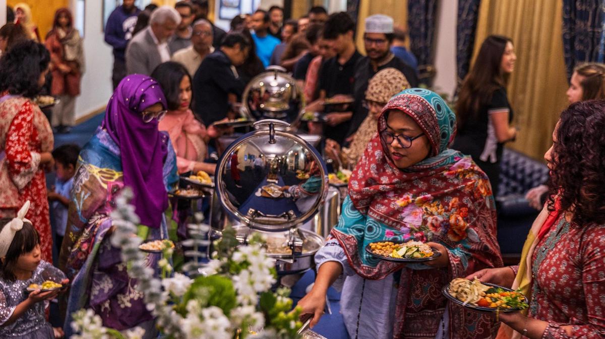 Attendees serve dinner themselves after a Maghrib prayer, during the Florida International University Jaffer Center for Muslim World Studies’ Annual Interfaith Iftar Dinner 2025 in observance of Ramadan