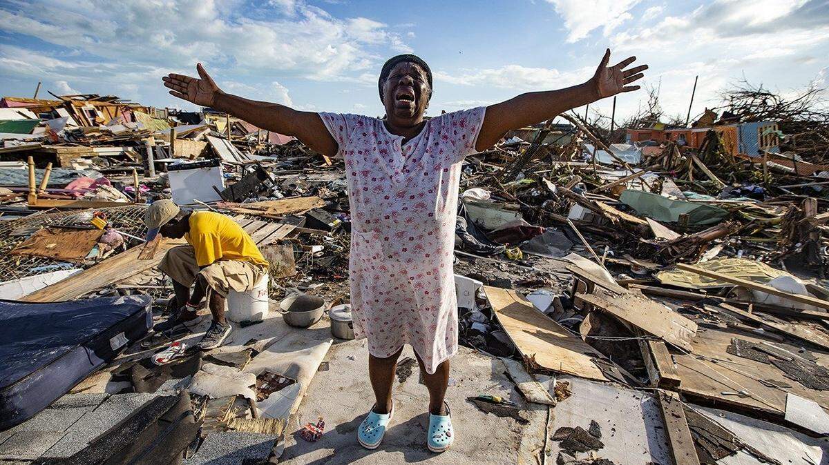 Aliana Alexis of Haiti stands on the concrete slab of what is left of her home after destruction from Hurricane Dorian in an area called “The Mud” at Marsh Harbour in Great Abaco Island, Bahamas, on Thursday, Sept. 5, 2019.