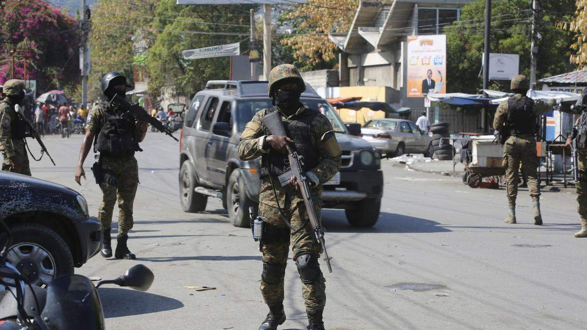 Members of the General Security Unit of the National Palace, USGPN, set up a security perimeter around one of the three downtown stations after police fought off an attack by gangs the day before, in Port-au-Prince, Haiti, Saturday, March 9, 2024. (AP Photo/Odelyn Joseph)