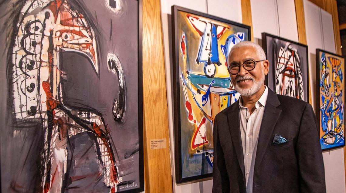 Renowned Haitian artist Philippe Dodard posed next to some of his recent pieces during the 2022 Caribbean Fine Art Exhibit and Awards reception to celebrate the 19th anniversary of the Haitian social and culture organization Le P’ti Club where he received a lifetime achievement award, in Plantation, on Friday September 16, 2022.