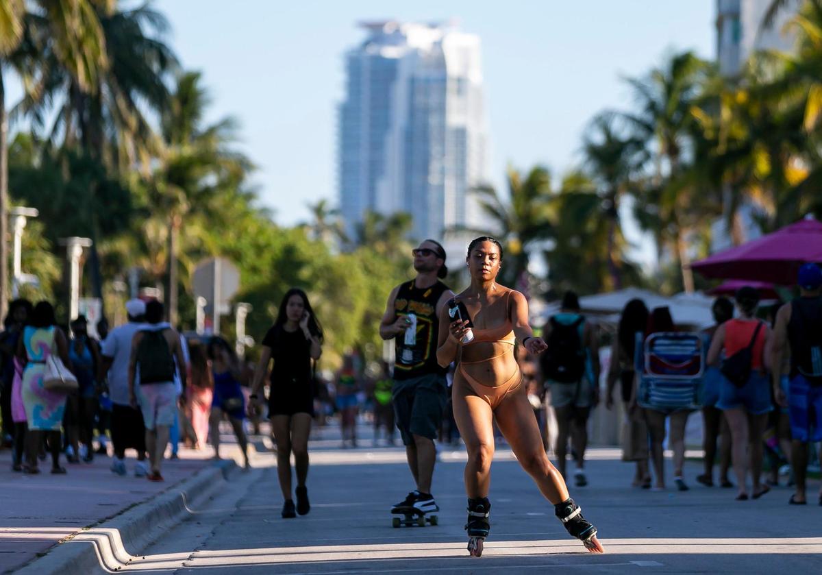South Beach visitors make their way down Ocean Drive in Miami Beach during the start of Memorial Day weekend on Friday, May 28, 2021.