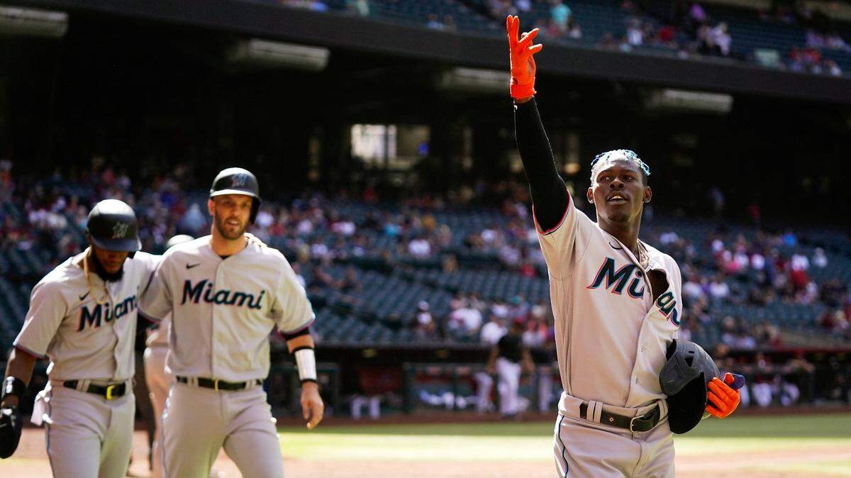 Miami Marlins’ Jazz Chisholm Jr., right, celebrates his three-run home run against the Arizona Diamondbacks with Marlins’ Jacob Stallings, middle, and Bryan De La Cruz, left, during the ninth inning of a baseball game Wednesday, May 11, 2022, in Phoenix.