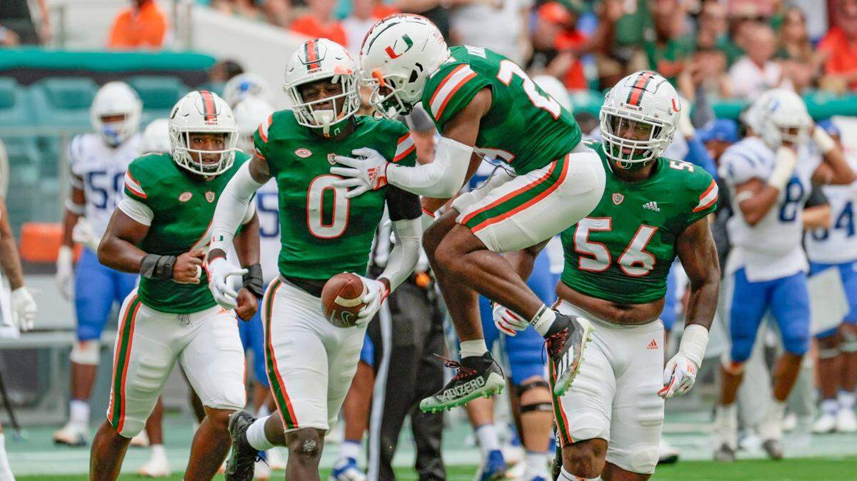 Miami Hurricanes safety Kamren Kinchens (24) celebrates with safety James Williams (0) after Williams intercepts the ball in the first quarter at Hard Rock Stadium in Miami Gardens on Saturday, October 22, 2022.
