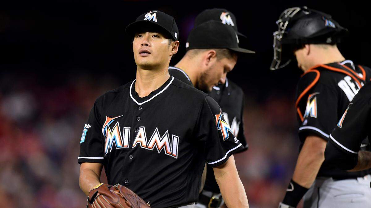 Miami Marlins starting pitcher Wei-Yin Chen, left, of Taiwan, leaves the field during the fifth inning of a baseball game against the Washington Nationals at Nationals Park in Washington, Saturday, July 7, 2018. (AP Photo/Susan Walsh)