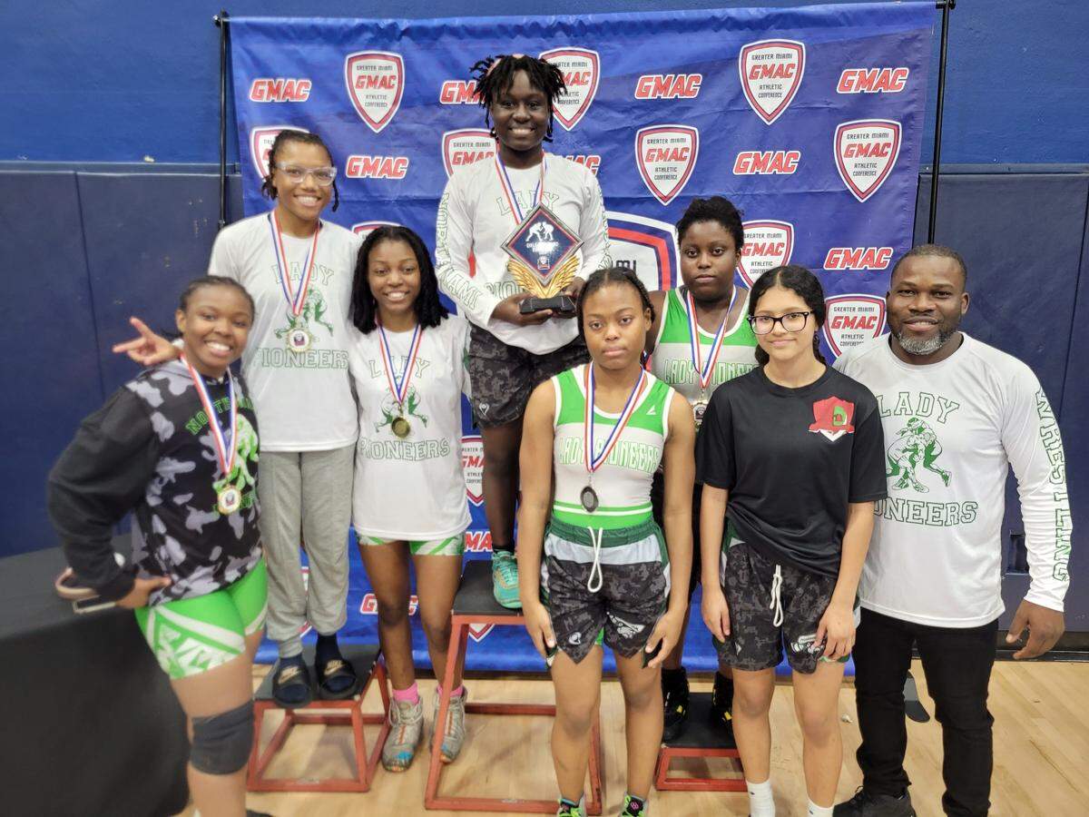 North Miami’s girls’ wrestling team celebrates after finishing runners-up for the third consecutive season at the GMAC championships, held Saturday at Miami Coral Park High School.