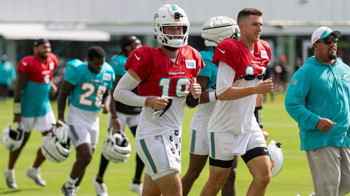 Miami Dolphins quarterbacks Skylar Thompson (19) and Mike White (14) make their way to the field during a joint practice session with the Atlanta Falcons at the Baptist Health Training Complex on Tuesday, Aug. 6, 2024, in Miami Gardens, Fla.