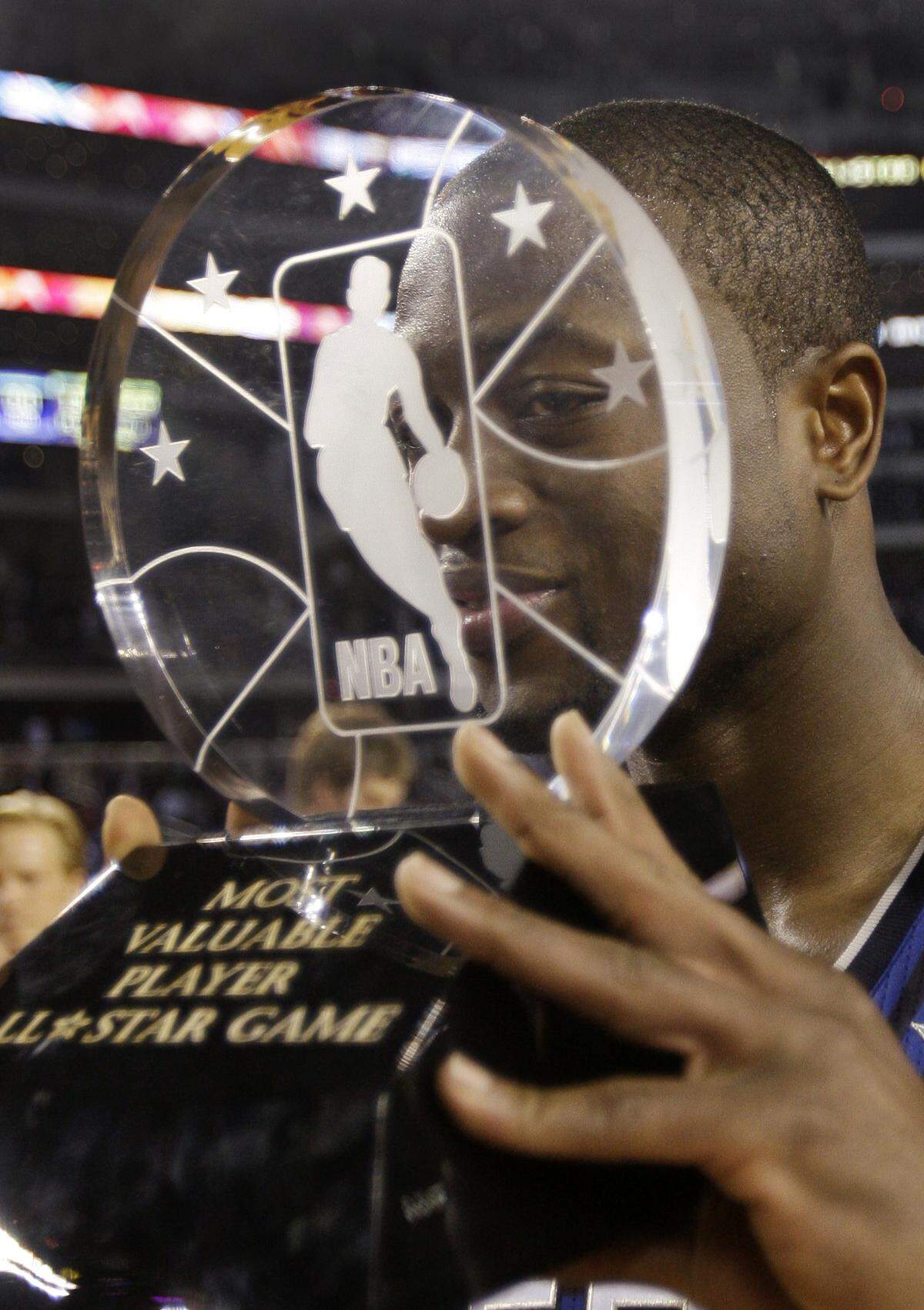 East All-Star Dwyane Wade of the Miami Heat jokes around as he holds up the MVP trophy after the East beat the West 141-139 in the NBA All-Star basketball game Sunday, Feb. 14, 2010, at Cowboys Stadium in Arlington, Texas. (AP Photo/Eric Gay)