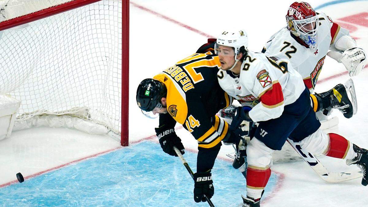Boston Bruins left wing Jake DeBrusk (74) scores on Florida Panthers goaltender Sergei Bobrovsky (72) after threading past defenseman Brandon Montour (62) during the second period of an NHL hockey game, Tuesday, April 26, 2022, in Boston. (AP Photo/Charles Krupa)