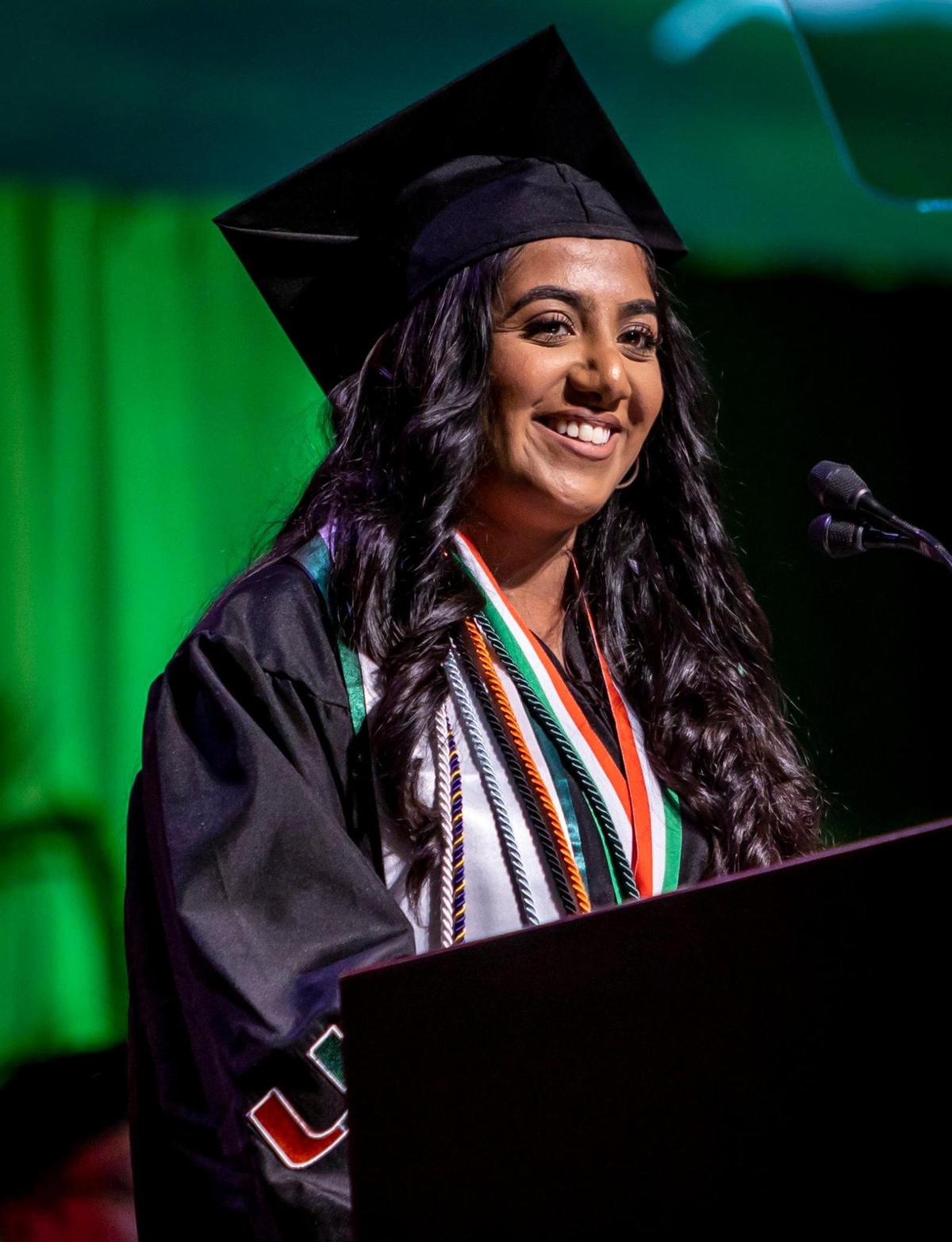 Graduate Iman Sami speaks to her class during UM’s spring commencement ceremonies Friday morning. Sami, an international student from England, mentioned her parents in her speech: “My parents sacrificed an immense amount — from supermarket cashier jobs to taxi driving throughout London in my childhood — to give me the privilege and honor of being able to afford and even have the opportunity to come here to the University of Miami. They also flew 10 hours and survived Miami immigration lines, and managed driving a rental car on the opposite side of the road all to make it here, so thank you very much!”
