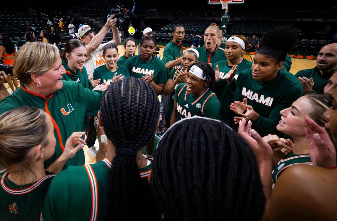 Miami Hurricanes Head Coach Tricia Cullop, left, talks to the team while Miami Hurricanes Ahnay Adams(5) yells after they won in overtime of the game against the Quinnipiac Bobcats on Sunday, Dec. 1, 2024, at Watsco Center in Coral Gables, Fla. Hurricanes won 83-74 in overtime.
