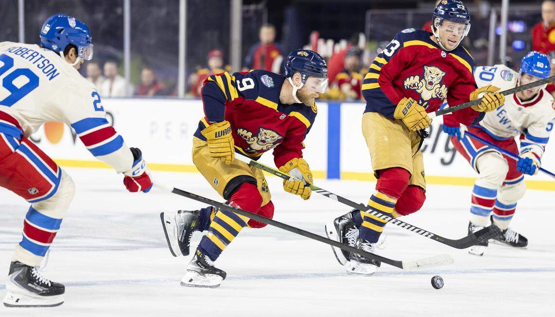 Florida Panthers center Sam Bennett (9) skates with the puck as New York Rangers defenseman Matthew Robertson (29) defends in the first period of their Winter Classic outdoor hockey game at loanDepot park on Friday, Jan. 2, 2026, in Miami, Fla.