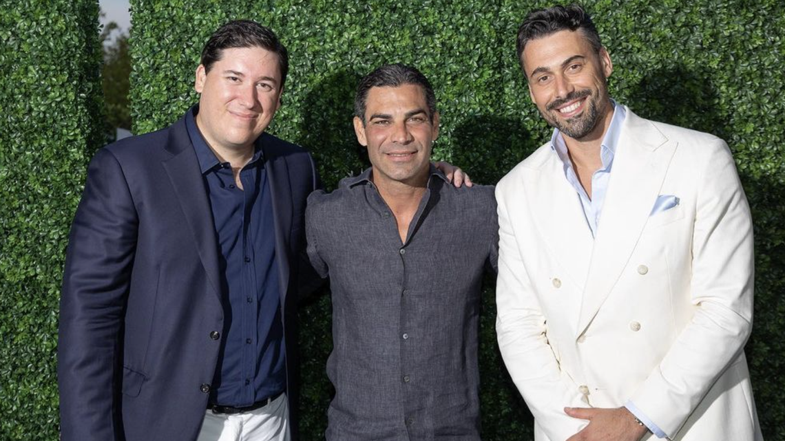 During the $6,000-per-person pop-up Once Upon a Kitchen, event coordinators Barnabas Carrega (left) and Luca Pavanelli (right) from hospitality group Gr8 Experience pose with Miami Mayor Francis Suarez (center).