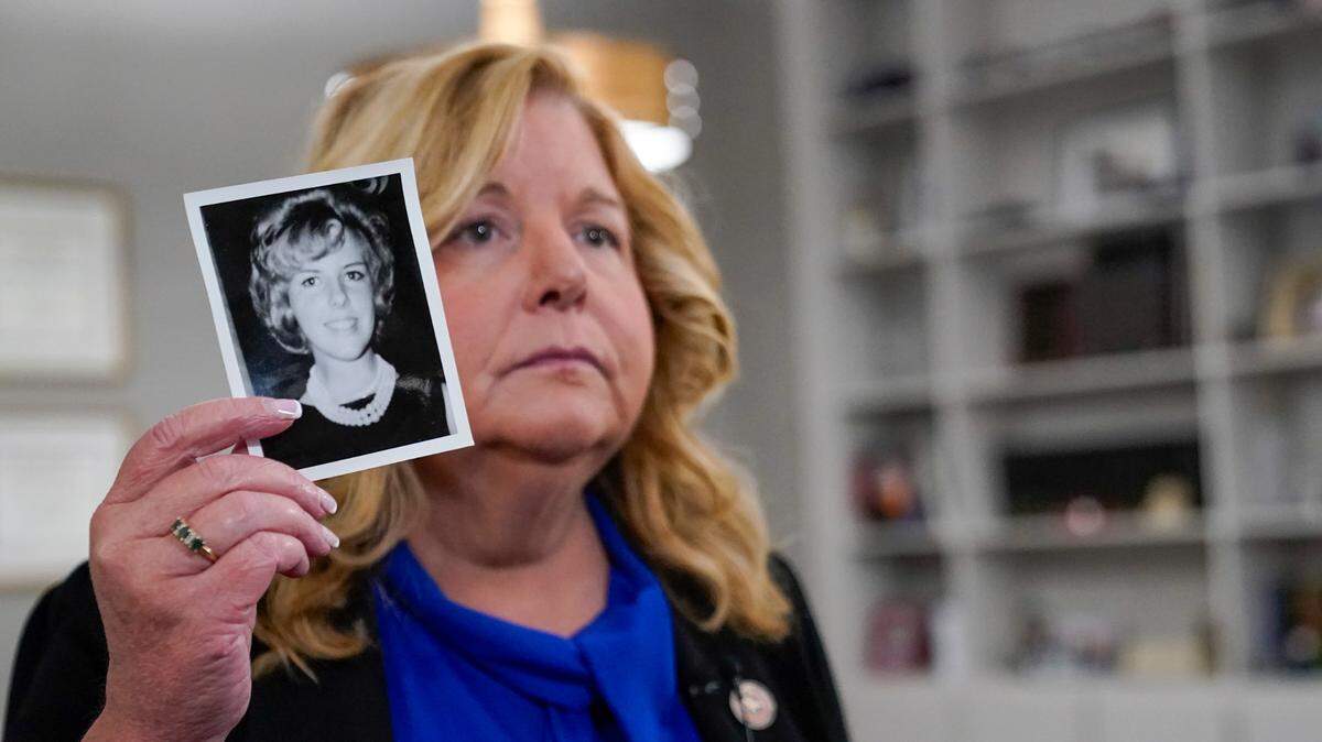 In this stock photo, the Nassau County District Attorney Anne Donnelly holds a photo of Diane Cusick during an interview with The Associated Press, Wednesday, June 22, 2022, in Mineola, N.Y.