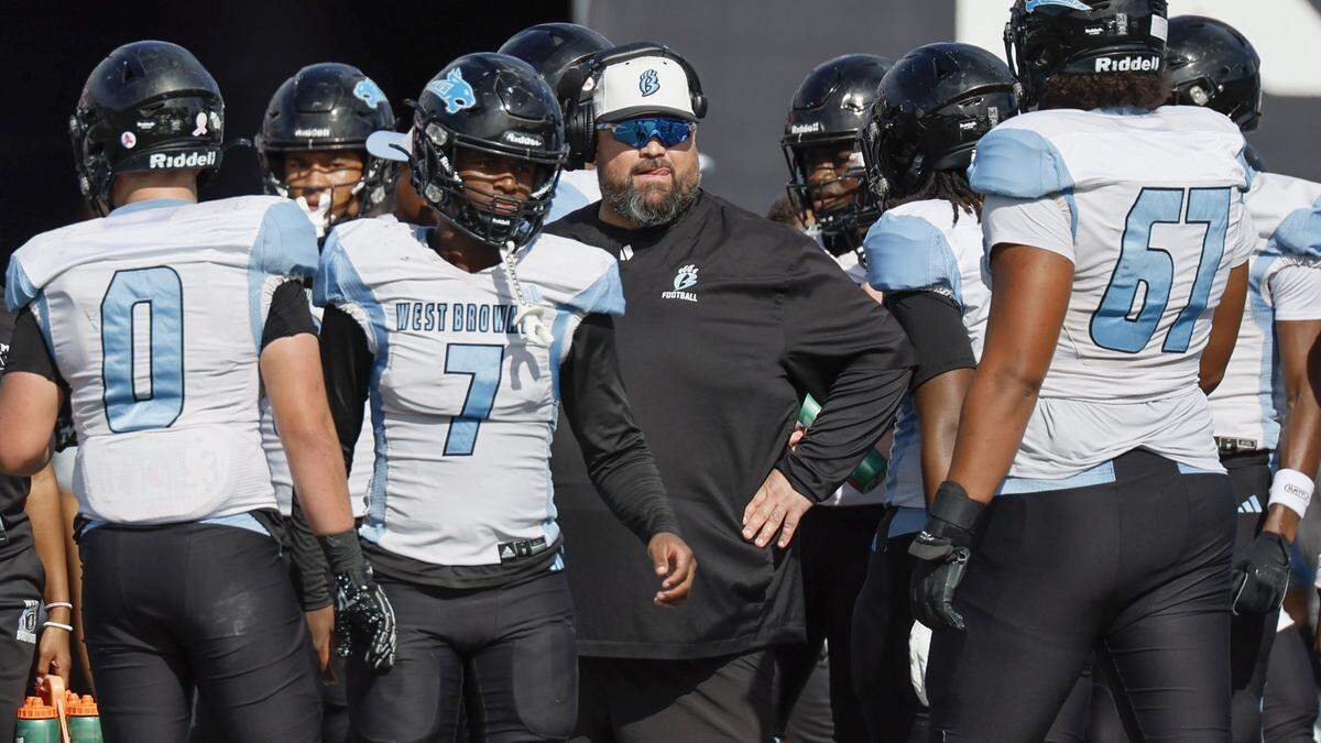West Broward Bobcats head coach Brian McCartney with players during a timeout in the game against West Boca Raton Bulls in Class 6A, Region 3 State Championship football game at FIU's Pitbull Stadium in Miami, Florida on Friday, December 12, 2025.