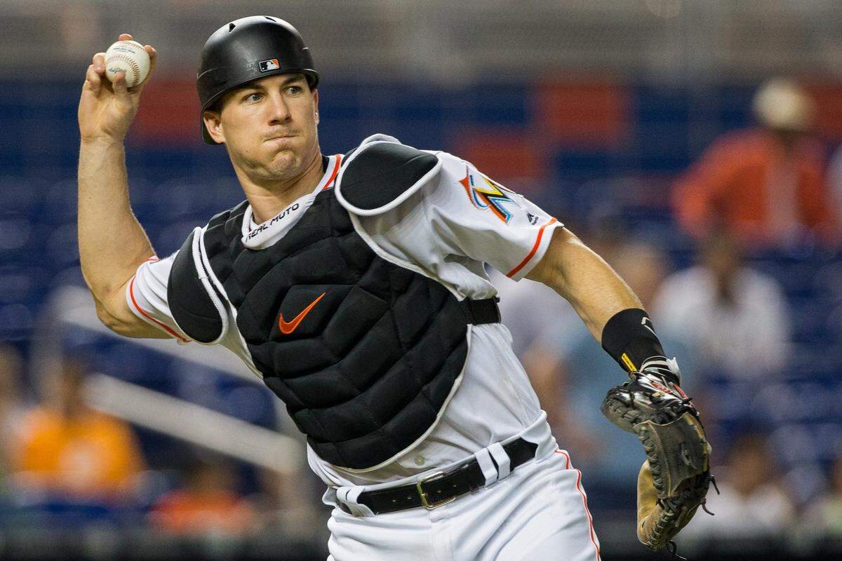 Miami Marlins catcher J.T. Realmuto (11) retires Atlanta Braves starting pitcher Sean Newcomb (15) on a sacrifice bunt in the sixth inning of the game at Marlins Park in Miami, Monday, July 23, 2018.