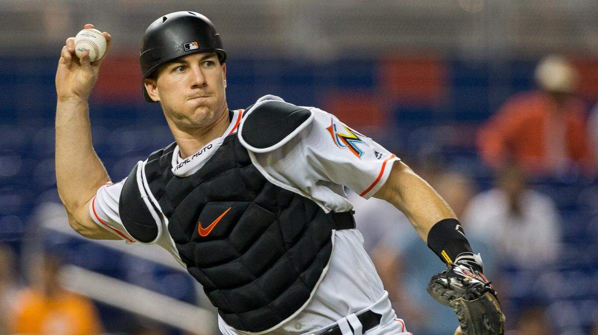 Miami Marlins catcher J.T. Realmuto (11) retires Atlanta Braves starting pitcher Sean Newcomb (15) on a sacrifice bunt in the sixth inning of the game at Marlins Park in Miami, Monday, July 23, 2018.