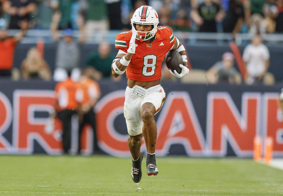 Miami Hurricanes defensive back Jakobe Thomas (8) intercepts for a touchdown in the first half of an NFL football game against the NC State Wolfpack at Hard Rock Stadium in Miami Gardens, Florida, on Saturday, November 15, 2025.