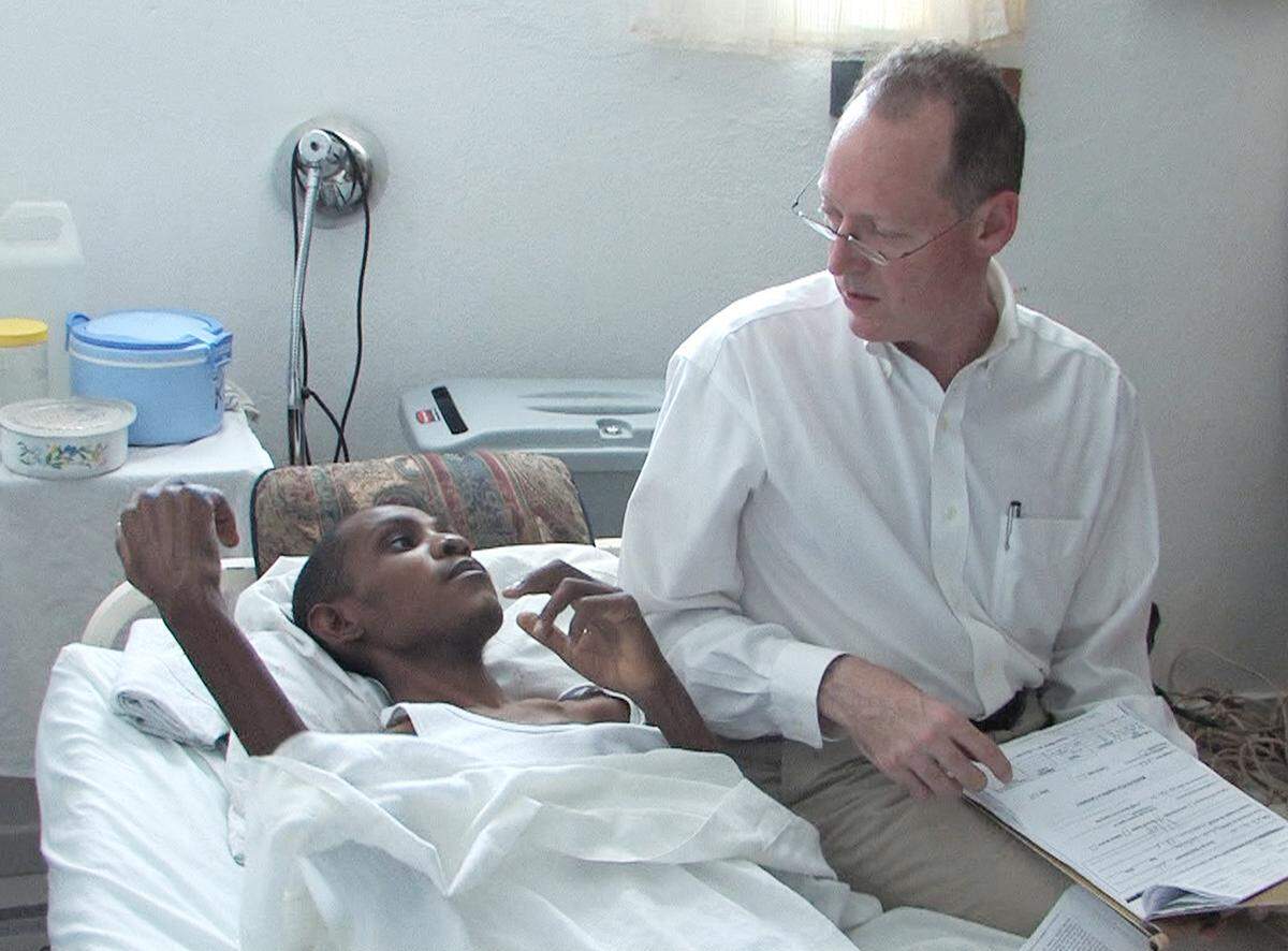 Dr. Paul Farmer treats a patient at a clinic in Cange, Haiti, in this file photo. Farmer began his lifelong commitment to Haiti in 1983 while still a student working with dispossessed farmers in Haiti’s Central Plateau.